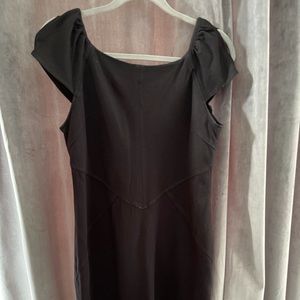 Black dress. Capped sleeve with slit.